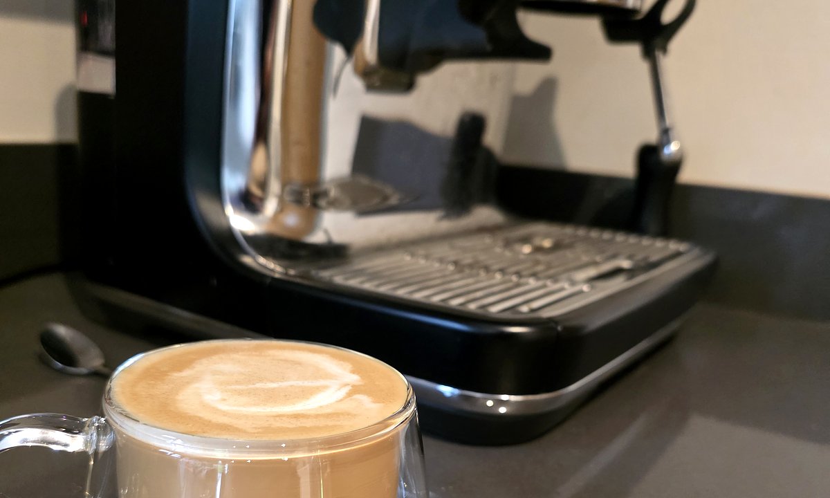 Sage Barista Pro Black Truffle with a flat white in the kitchen